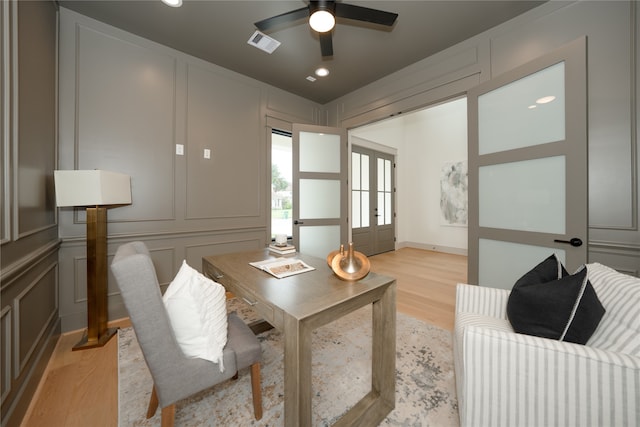 office area with light wood-type flooring and ceiling fan