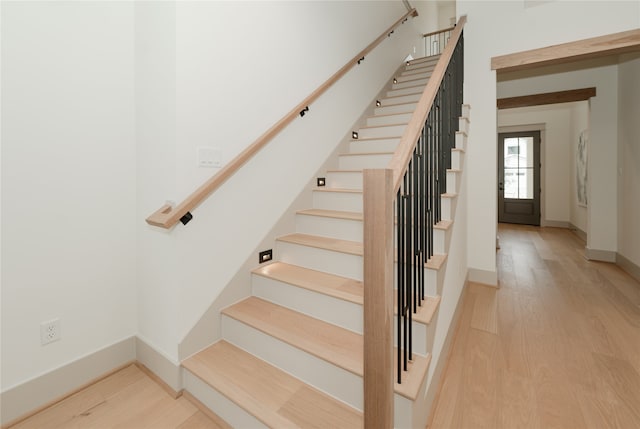 staircase with wood-type flooring