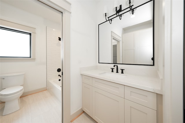 full bathroom with vanity, tiled shower / bath combo, and toilet