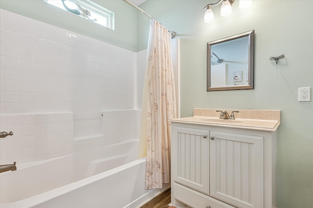 bathroom featuring shower / bathtub combination with curtain, hardwood / wood-style flooring, and vanity