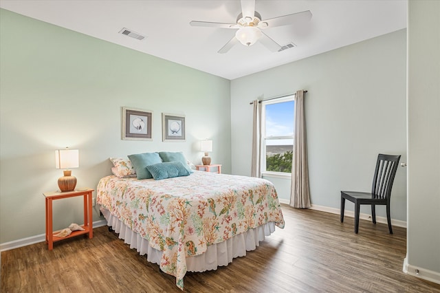 bedroom with dark hardwood / wood-style flooring and ceiling fan