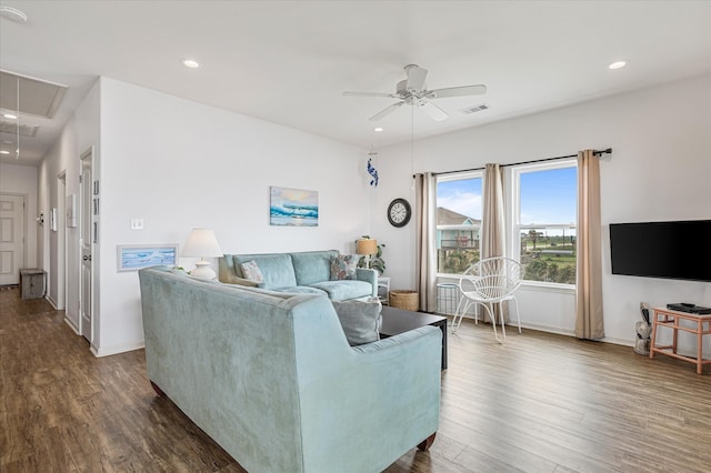 living room with ceiling fan and dark wood-type flooring