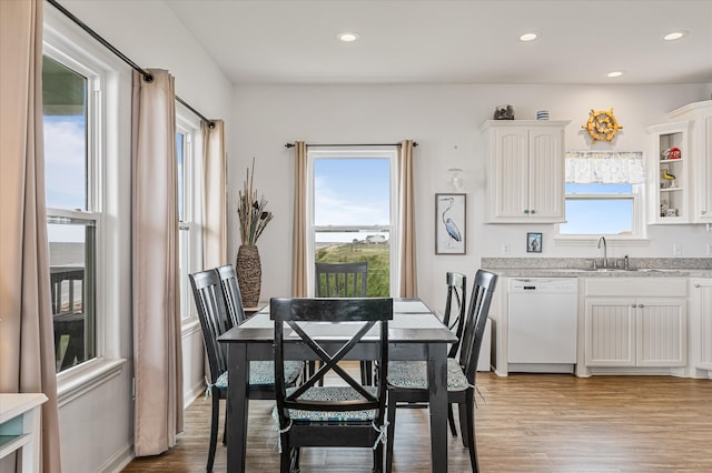 dining space featuring sink and light hardwood / wood-style floors