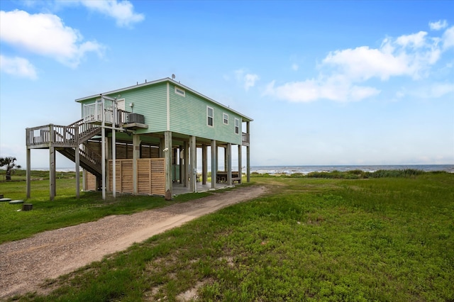 exterior space with a water view and a yard