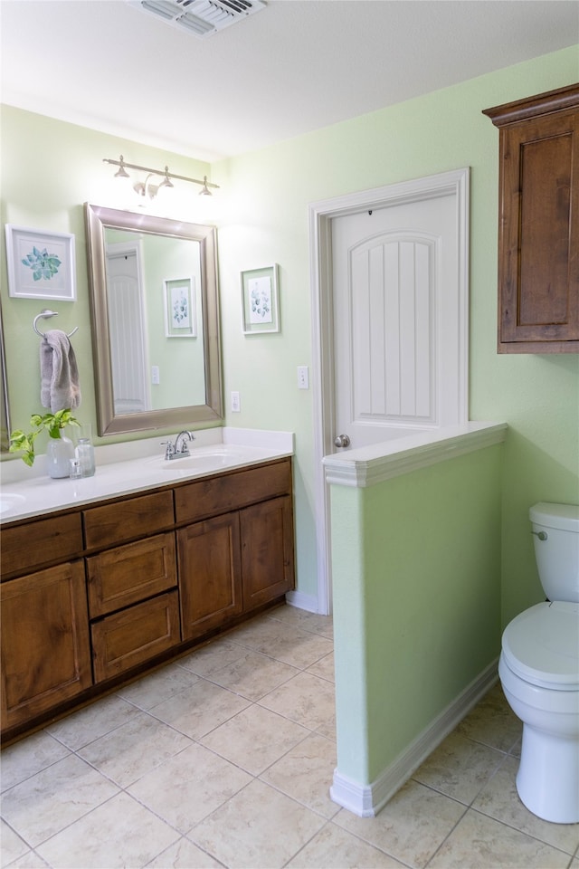 bathroom featuring vanity, toilet, and tile patterned floors