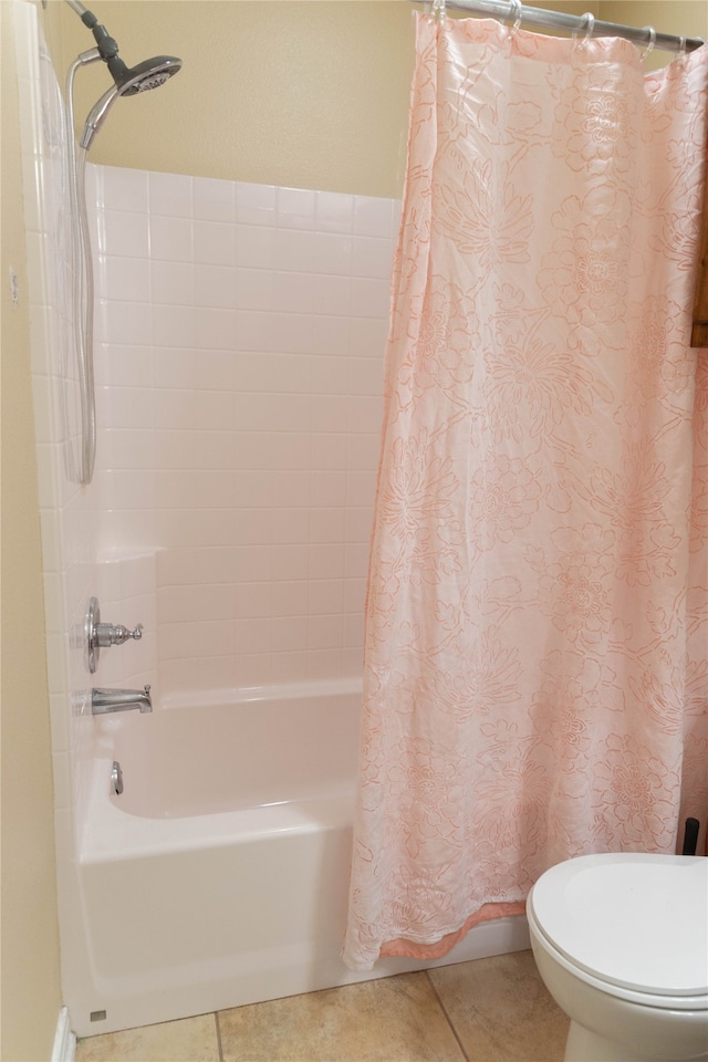 bathroom featuring shower / bath combination with curtain, tile patterned floors, and toilet