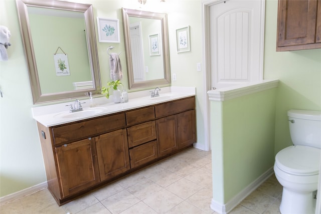 bathroom featuring vanity, tile patterned flooring, and toilet