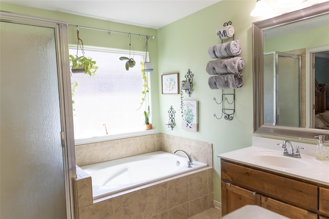 bathroom featuring shower with separate bathtub and vanity