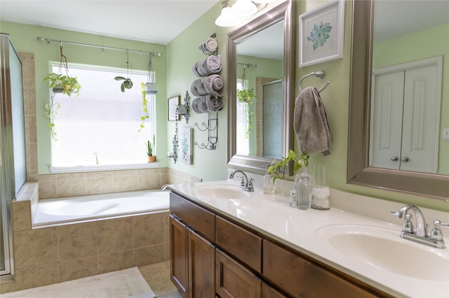 bathroom featuring independent shower and bath, vanity, and tile patterned floors