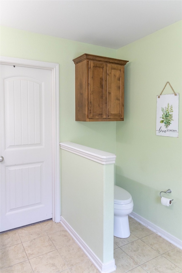 bathroom featuring tile patterned flooring and toilet