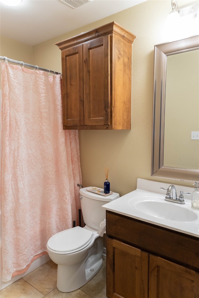 bathroom with walk in shower, tile patterned flooring, vanity, and toilet