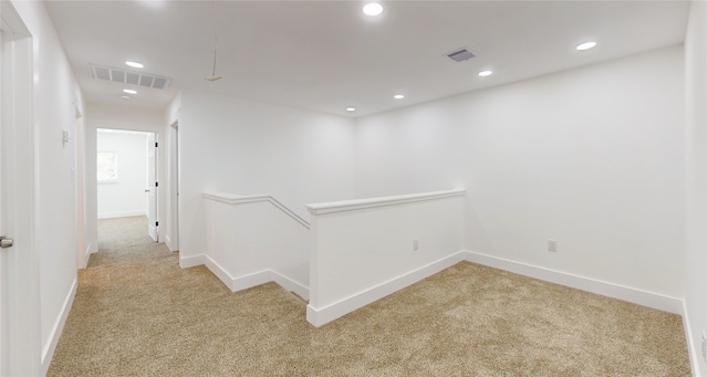 hallway featuring light carpet