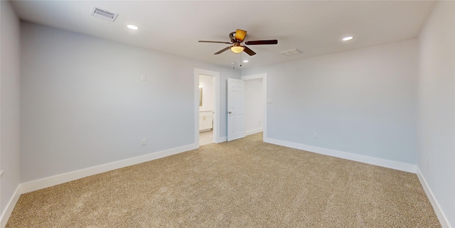 empty room featuring ceiling fan and light colored carpet