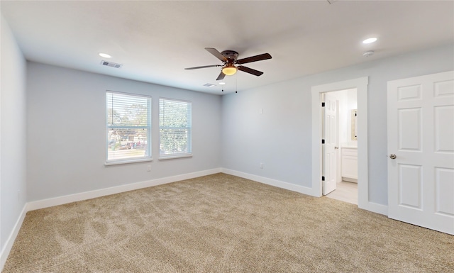 empty room with light colored carpet and ceiling fan