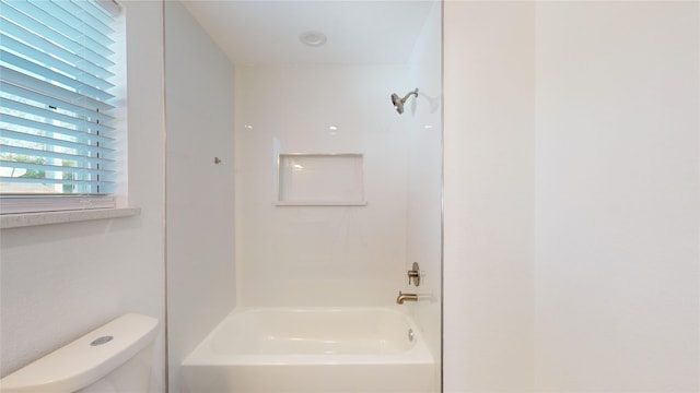 bathroom with toilet and  shower combination