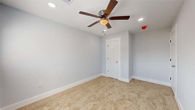 unfurnished bedroom featuring light colored carpet and ceiling fan