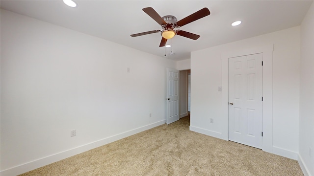 unfurnished bedroom with ceiling fan, a closet, and light colored carpet