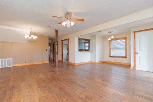 interior space with hardwood / wood-style flooring, ceiling fan with notable chandelier, and a textured ceiling