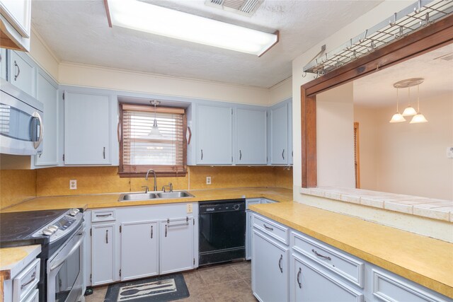 kitchen featuring light tile patterned floors, sink, a textured ceiling, decorative light fixtures, and appliances with stainless steel finishes