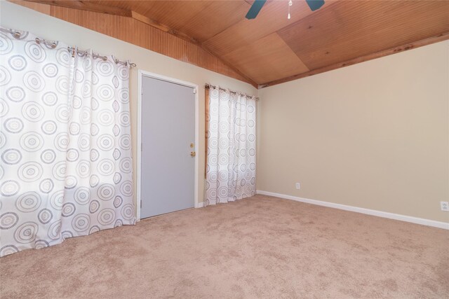 carpeted empty room with wood ceiling, vaulted ceiling, and ceiling fan