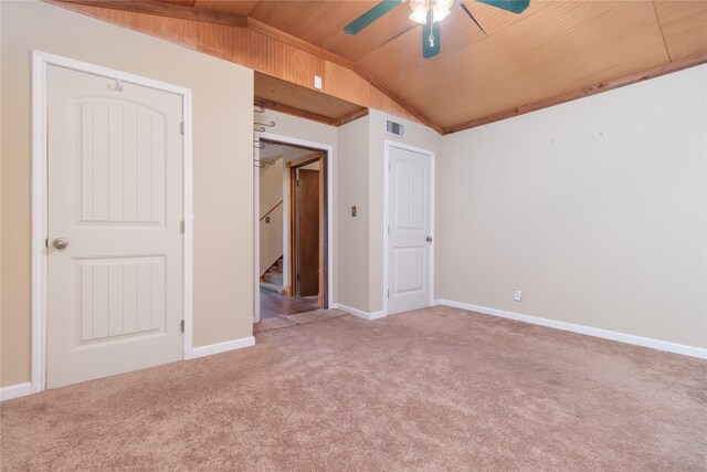 carpeted spare room featuring ceiling fan, wood ceiling, and vaulted ceiling