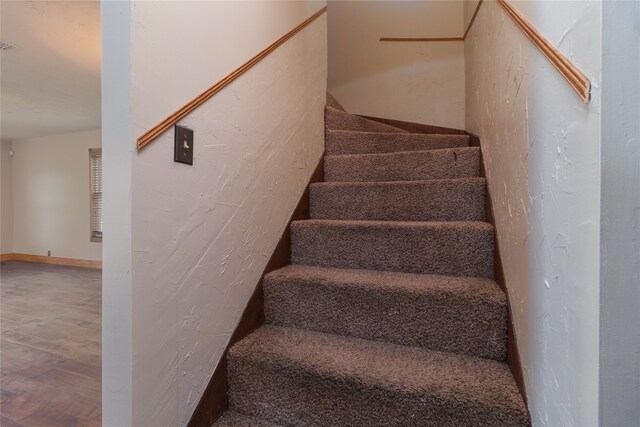 stairway with wood-type flooring