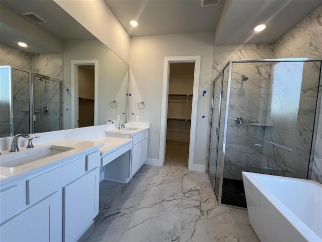 full bathroom with marble finish floor, recessed lighting, a shower stall, vanity, and a freestanding tub