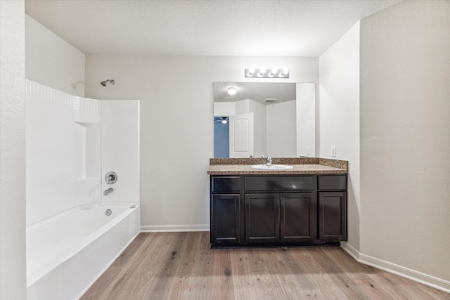 bathroom with vanity, shower / bathing tub combination, and hardwood / wood-style flooring