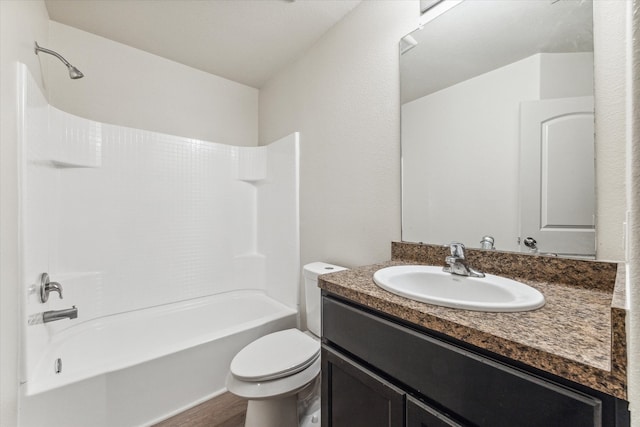 full bathroom with washtub / shower combination, vanity, toilet, and hardwood / wood-style flooring