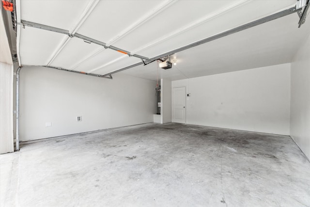 garage featuring a garage door opener and electric water heater