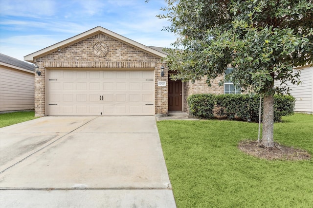 view of front of property with a front yard and a garage