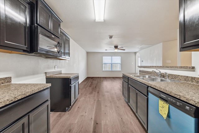 kitchen featuring ceiling fan, sink, a textured ceiling, dishwasher, and light hardwood / wood-style floors