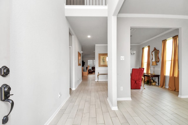 interior space with light hardwood / wood-style flooring and ornamental molding