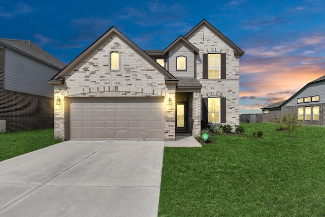 view of front of house with a lawn and a garage