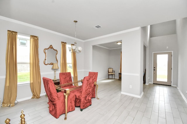 dining room featuring a notable chandelier, light wood-type flooring, and crown molding