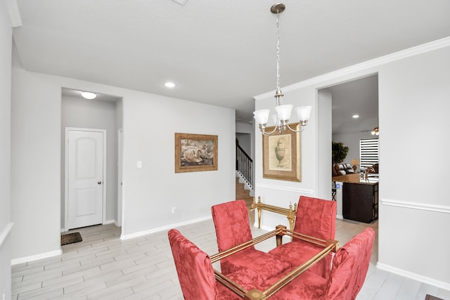 dining area featuring ornamental molding, light wood-type flooring, and a chandelier