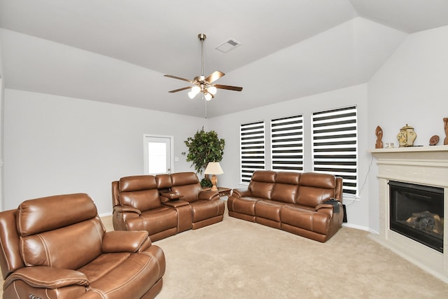 carpeted living room featuring vaulted ceiling and ceiling fan