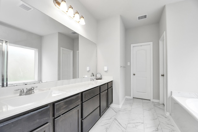 bathroom featuring vanity and a washtub