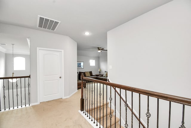 hallway with light colored carpet