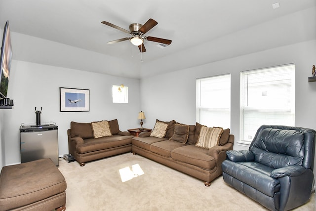 living room with ceiling fan and light colored carpet