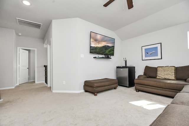 living room featuring carpet, vaulted ceiling, and ceiling fan