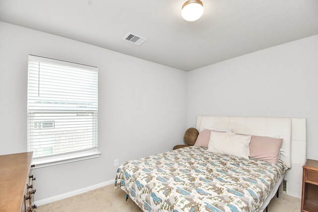 bedroom featuring light carpet