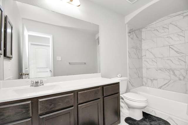 full bathroom with vanity, toilet, and tiled shower / bath