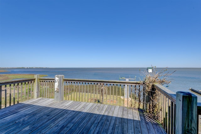 wooden terrace featuring a water view