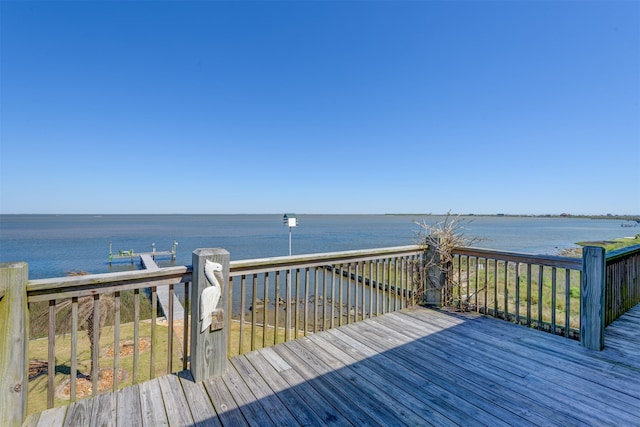 wooden deck featuring a water view