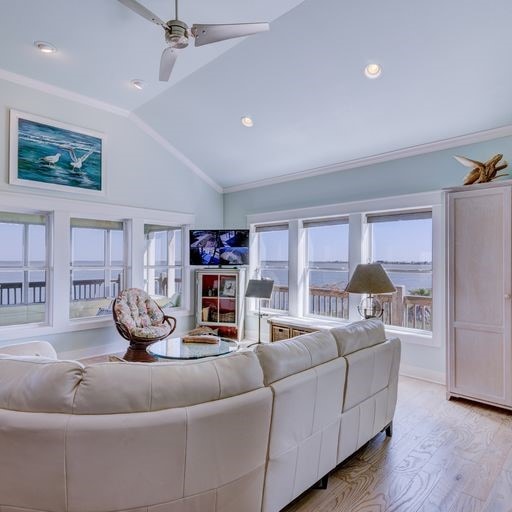 1038 Elizabeth St, Gilchrist, TX 77617 - living room featuring vaulted ceiling, a ceiling fan, light wood-style floors, crown molding, and recessed lighting