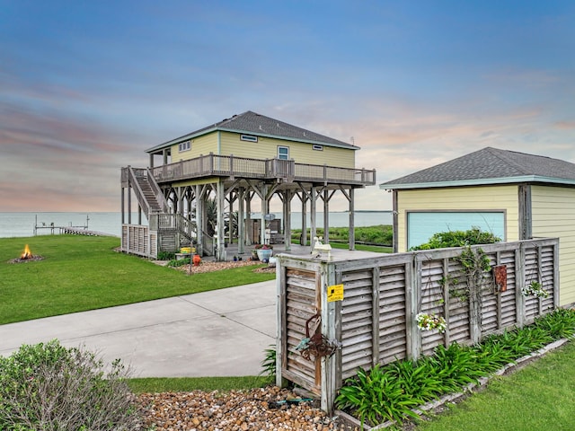 1038 Elizabeth St, Gilchrist, TX 77617 - view of property's community with a lawn, stairs, a patio, and a deck with water view