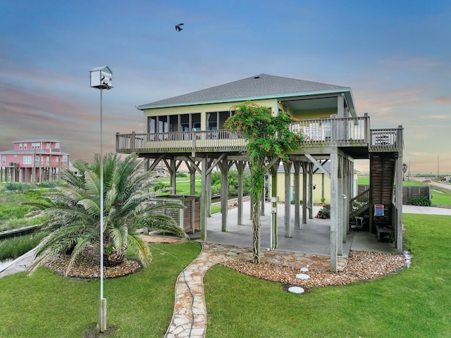 1038 Elizabeth St, Gilchrist, TX 77617 - view of home's community with a wooden deck and a lawn