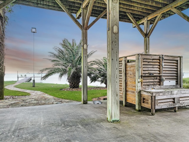 1038 Elizabeth St, Gilchrist, TX 77617 - patio terrace at dusk featuring a yard and a water view