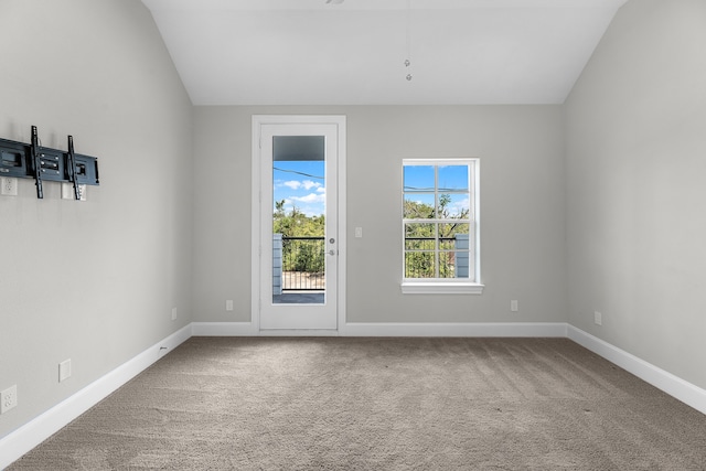 carpeted spare room with lofted ceiling